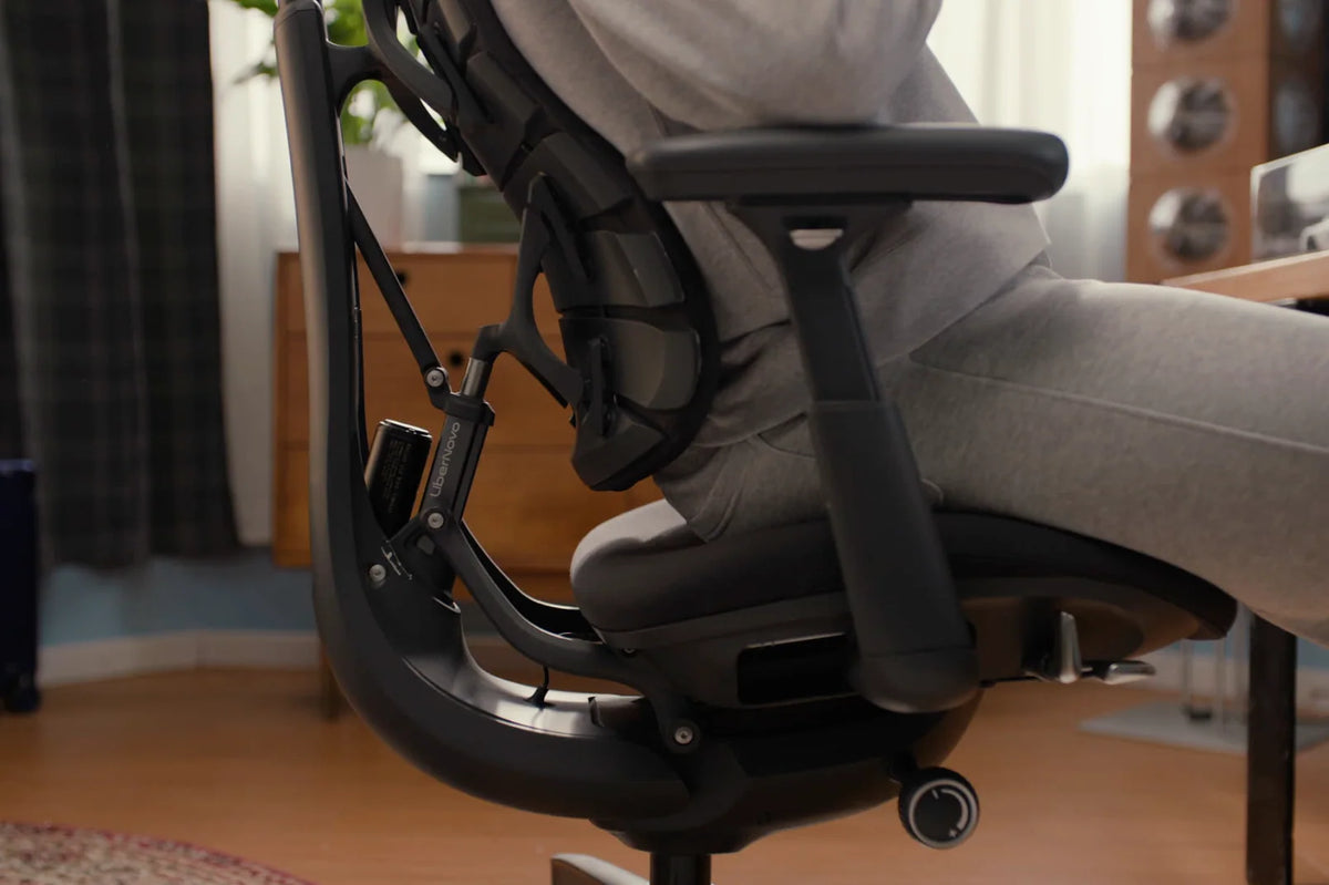 Person sitting in the LiberNovo Omni chair, side view of the back mechanism and seat